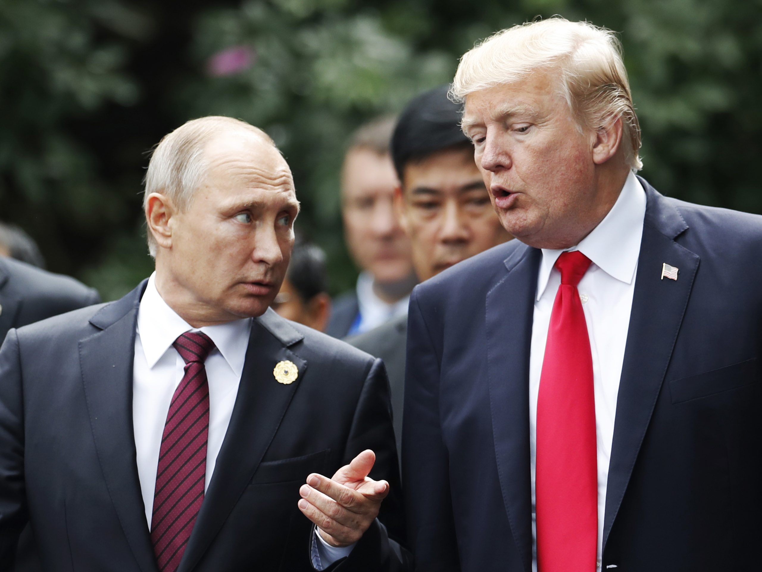 President Trump and Russian President Vladimir Putin talk during the family photo session at the APEC Summit in Danang, Vietnam, on Saturday.